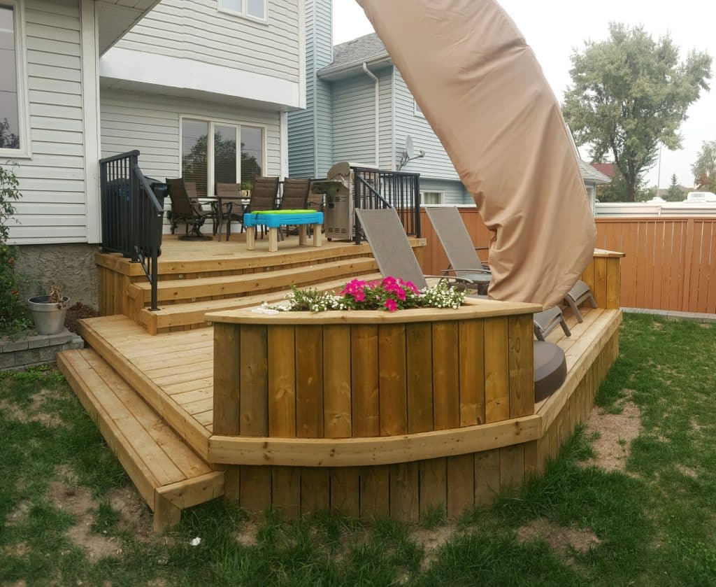 Ground level pressure-treated deck built in Calgary backyard