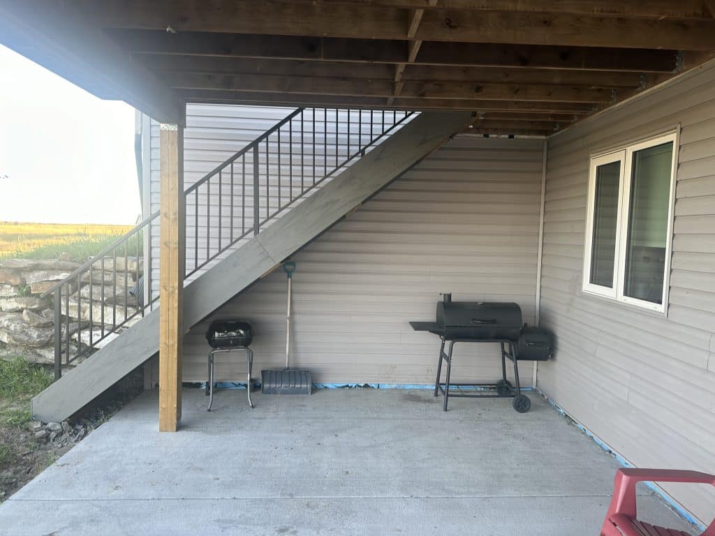 underside of composite walkout deck with stairs and patio space in Strathmore Alberta