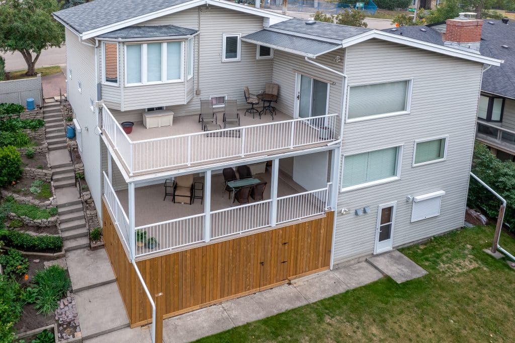 Multi-level backyard deck built in Calgary with two outdoor living spaces