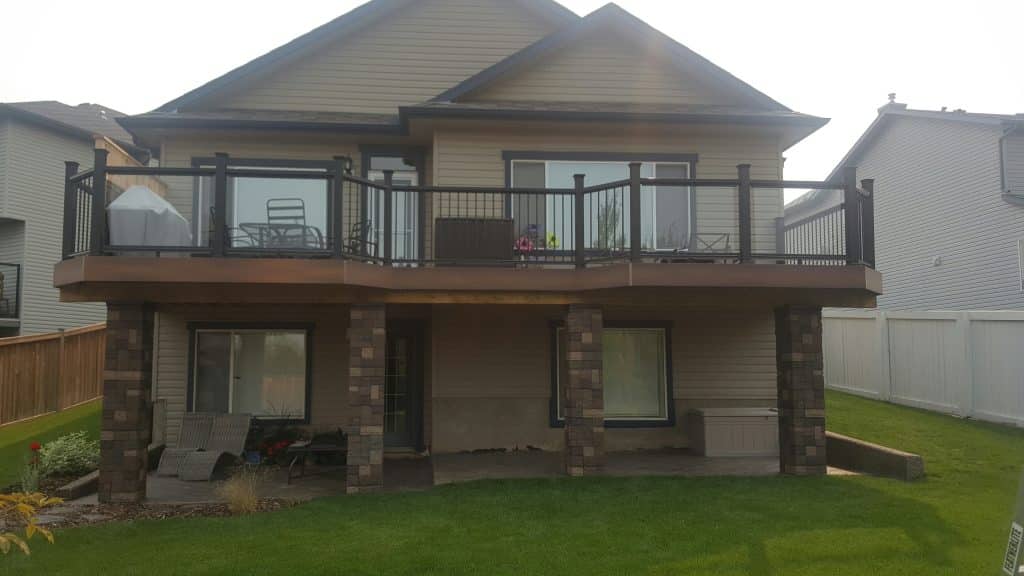 Walkout backyard deck with composite railing built in Calgary by Pemadale